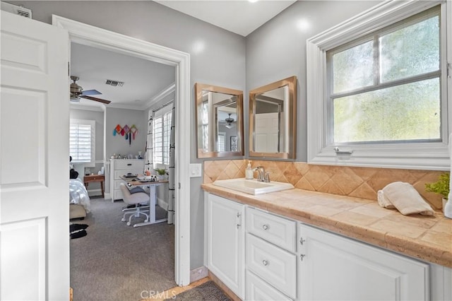 22550 Flamingo St, Woodland Hills, CA 91364 - bathroom with ceiling fan, vanity, crown molding, and tasteful backsplash