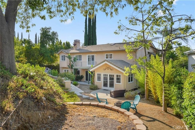 22550 Flamingo St, Woodland Hills, CA 91364 - rear view of property featuring french doors, a balcony, stucco siding, a patio, and a chimney