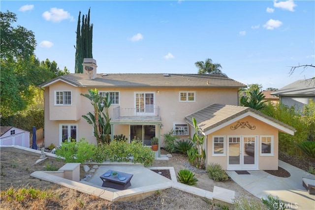 22550 Flamingo St, Woodland Hills, CA 91364 - back of house with french doors, a balcony, stucco siding, and a patio area