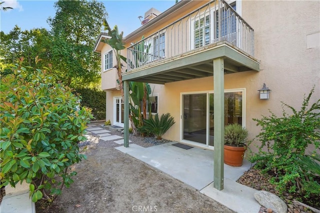 22550 Flamingo St, Woodland Hills, CA 91364 - rear view of house with a balcony, stucco siding, and a patio
