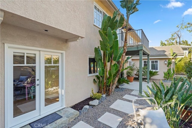 22550 Flamingo St, Woodland Hills, CA 91364 - view of home's exterior featuring stucco siding, a patio, a balcony, and french doors