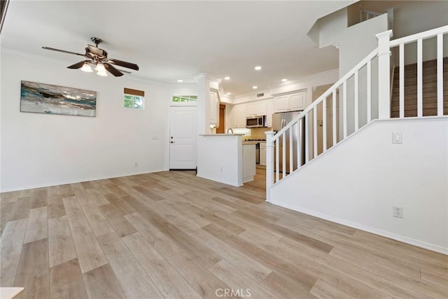 72 Westwind Dr, Tustin, CA 92782 - unfurnished living room with a ceiling fan, stairs, ornamental molding, recessed lighting, and light wood-style flooring