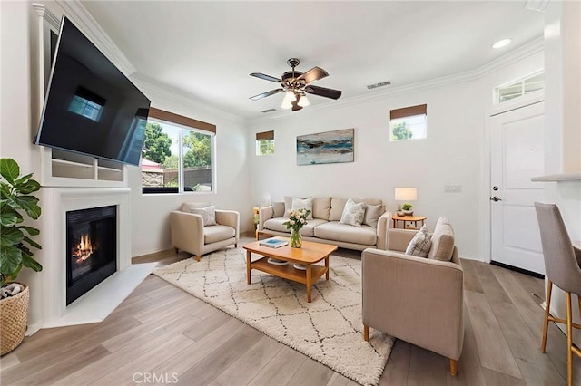 72 Westwind Dr, Tustin, CA 92782 - living area featuring crown molding, light wood finished floors, healthy amount of natural light, a ceiling fan, and recessed lighting