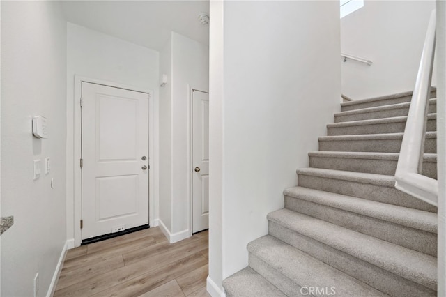 3908 Boulder Dr, Jurupa Valley, CA 92509 - staircase featuring wood finished floors and baseboards