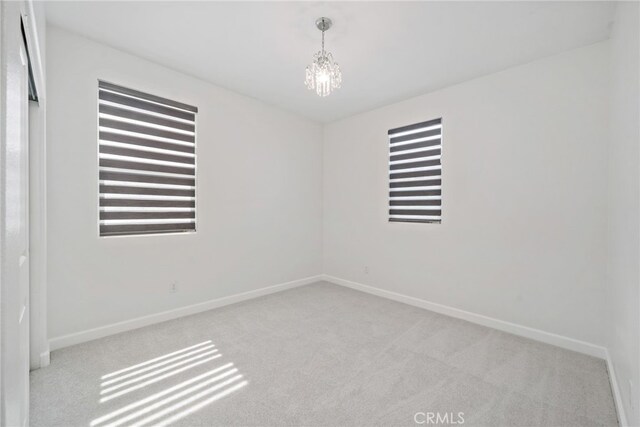 3908 Boulder Dr, Jurupa Valley, CA 92509 - unfurnished room with carpet flooring and a chandelier