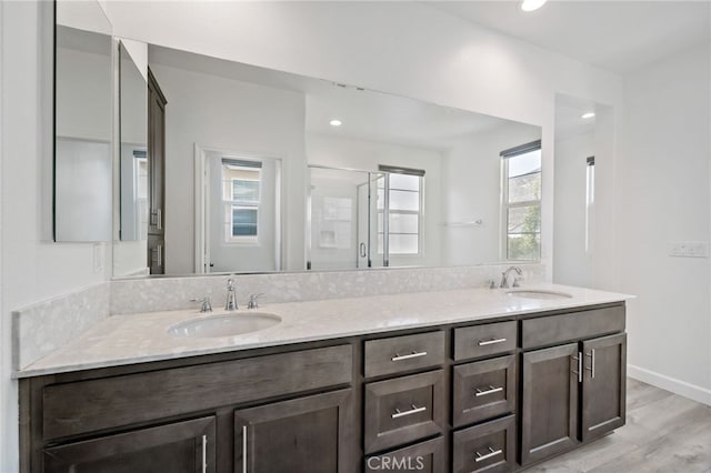 3908 Boulder Dr, Jurupa Valley, CA 92509 - full bath featuring double vanity, plenty of natural light, wood finished floors, a stall shower, and recessed lighting