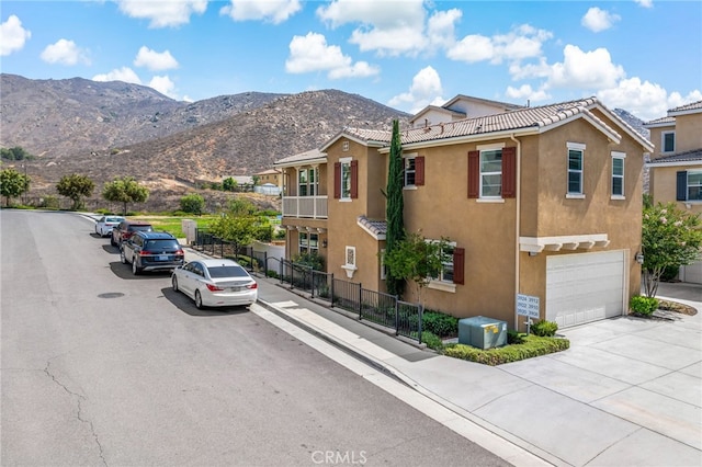 3908 Boulder Dr, Jurupa Valley, CA 92509 - view of asphalt road with sidewalks, a mountain view, and curbs