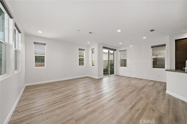 3908 Boulder Dr, Jurupa Valley, CA 92509 - unfurnished living room with healthy amount of natural light, light wood finished floors, and recessed lighting