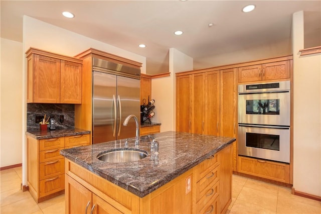 4570 Christine Loomis Dr, Arroyo Grande, CA 93420 - kitchen featuring stainless steel appliances, light tile patterned floors, a center island with sink, decorative backsplash, and recessed lighting