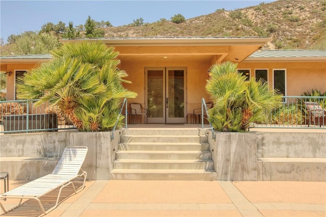 4570 Christine Loomis Dr, Arroyo Grande, CA 93420 - entrance to property with stucco siding, a mountain view, covered porch, and a metal roof