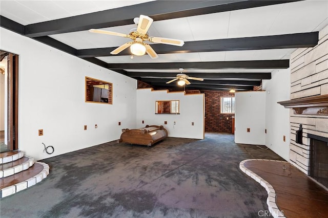 9649 Grace St, Fontana, CA 92335 - carpeted living area with a stone fireplace, beam ceiling, and ceiling fan