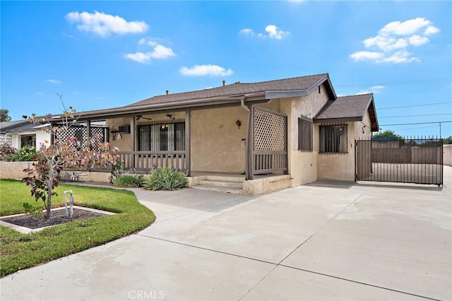 9649 Grace St, Fontana, CA 92335 - view of front facade featuring stucco siding, covered porch, and driveway