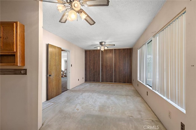 9649 Grace St, Fontana, CA 92335 - unfurnished room featuring ceiling fan, light colored carpet, and a textured ceiling