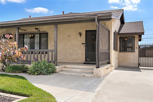 9649 Grace St, Fontana, CA 92335 - view of exterior entry featuring stucco siding and roof with shingles