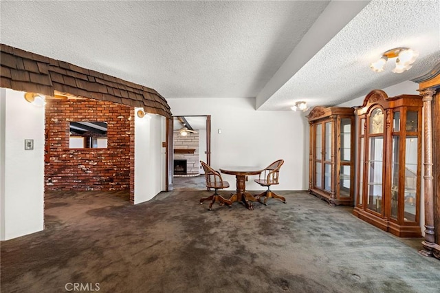 9649 Grace St, Fontana, CA 92335 - living area featuring a fireplace, a textured ceiling, carpet floors, and brick wall