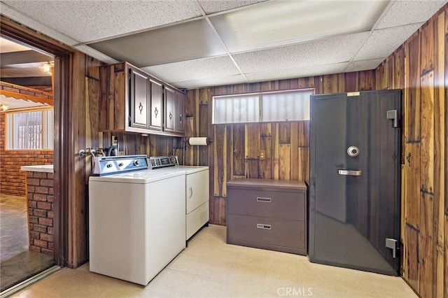 9649 Grace St, Fontana, CA 92335 - laundry area featuring cabinet space, washer and clothes dryer, light floors, and wood walls