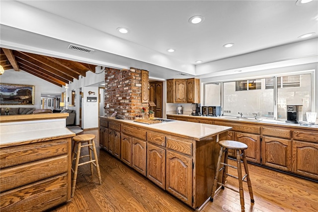 1146 Sandhurst Ln, La Verne, CA 91750 - kitchen with hardwood / wood-style flooring, brown cabinetry, light countertops, stovetop, and recessed lighting