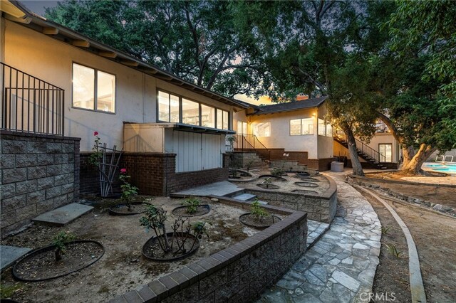 1146 Sandhurst Ln, La Verne, CA 91750 - back of property featuring stairs, stucco siding, brick siding, and a patio area