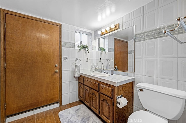 1146 Sandhurst Ln, La Verne, CA 91750 - bathroom featuring vanity, tile walls, and wood finished floors