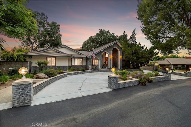 1146 Sandhurst Ln, La Verne, CA 91750 - view of front of property with stone siding, stucco siding, and curved driveway