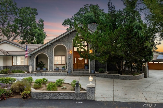 1146 Sandhurst Ln, La Verne, CA 91750 - view of front of house with brick siding, a tile roof, and a chimney