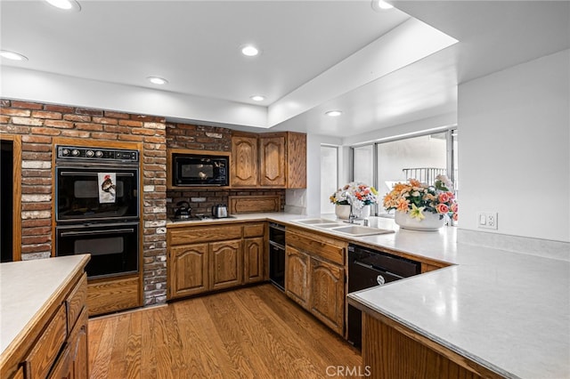 1146 Sandhurst Ln, La Verne, CA 91750 - kitchen featuring black appliances, light countertops, light wood finished floors, brown cabinetry, and recessed lighting