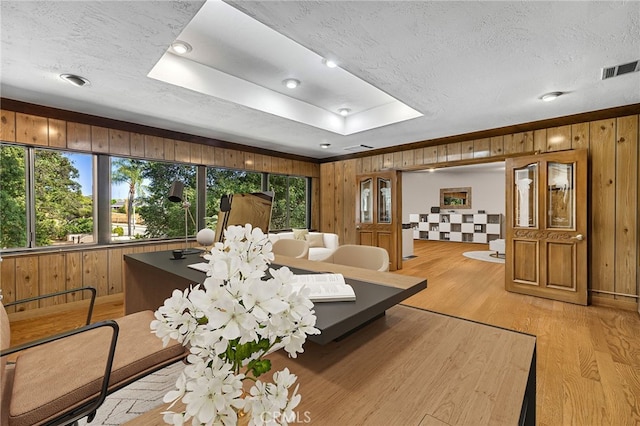 1146 Sandhurst Ln, La Verne, CA 91750 - living area with light wood finished floors, wood walls, a tray ceiling, and a textured ceiling