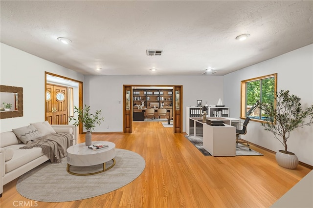 1146 Sandhurst Ln, La Verne, CA 91750 - living area featuring an office area, light wood finished floors, and a textured ceiling