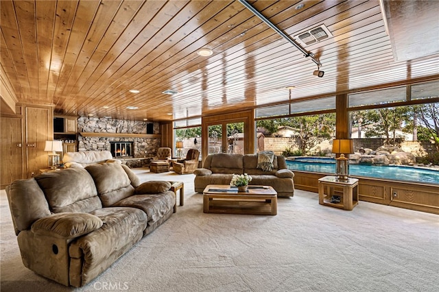 1146 Sandhurst Ln, La Verne, CA 91750 - living room with wooden ceiling, carpet floors, a stone fireplace, and wood walls