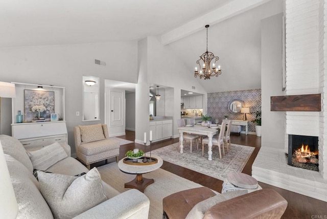 1247 La Casa Dr, San Marcos, CA 92078 - living room with dark wood-type flooring, high vaulted ceiling, a chandelier, a fireplace, and beam ceiling