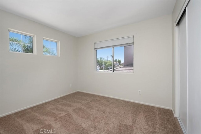 25134 Calle Viejo, Murrieta, CA 92563 - unfurnished bedroom featuring multiple windows, carpet flooring, and a closet