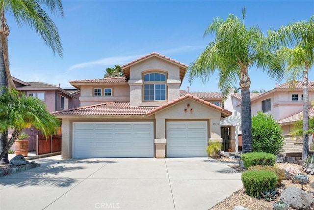 25134 Calle Viejo, Murrieta, CA 92563 - mediterranean / spanish home featuring concrete driveway, stucco siding, a tile roof, and an attached garage