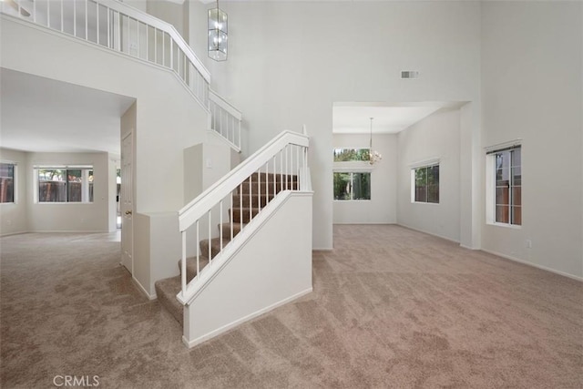 25134 Calle Viejo, Murrieta, CA 92563 - stairway with a high ceiling, carpet floors, and a chandelier