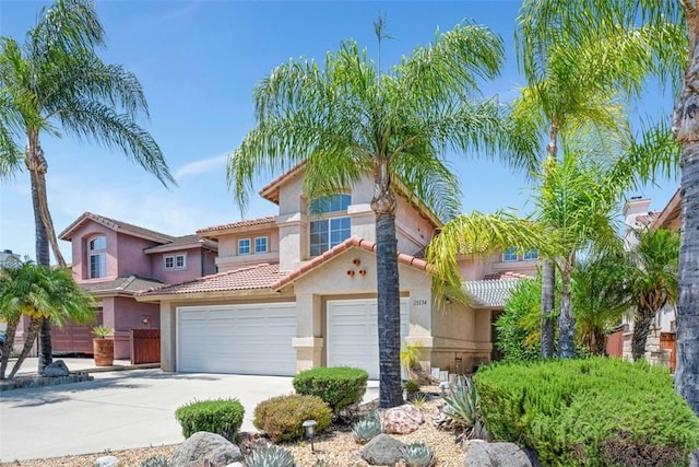 25134 Calle Viejo, Murrieta, CA 92563 - view of front facade with concrete driveway, stucco siding, a tiled roof, and a garage