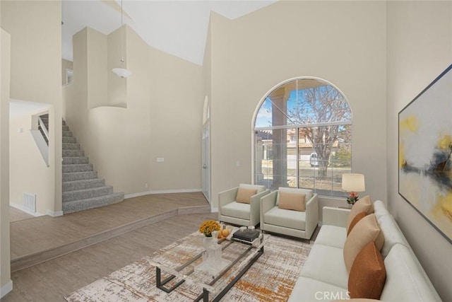 2608 W Oldfield St, Lancaster, CA 93536 - living area featuring a high ceiling, wood finished floors, and stairway