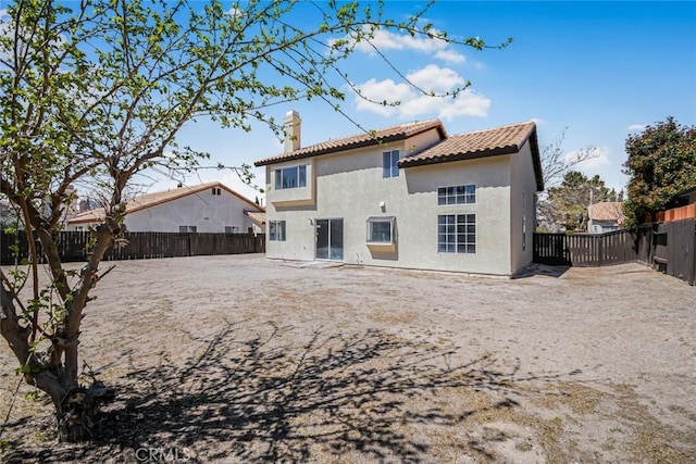 2608 W Oldfield St, Lancaster, CA 93536 - back of property with a chimney, a fenced backyard, stucco siding, and a tiled roof