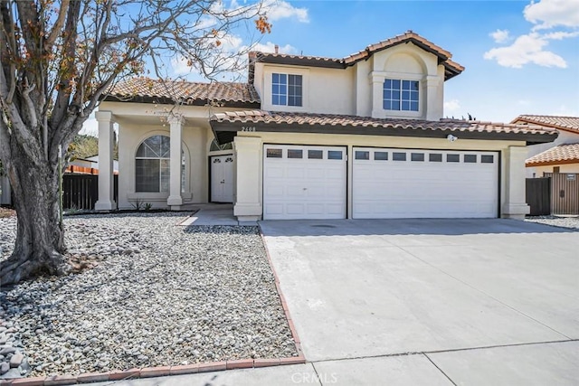 2608 W Oldfield St, Lancaster, CA 93536 - mediterranean / spanish-style home featuring concrete driveway, stucco siding, a tile roof, and an attached garage