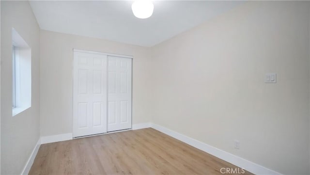 815 N Hagar St, San Fernando, CA 91340 - unfurnished bedroom with light wood-style flooring and a closet