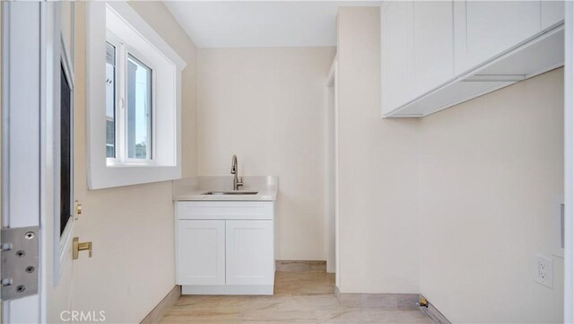 815 N Hagar St, San Fernando, CA 91340 - laundry room featuring a sink and baseboards