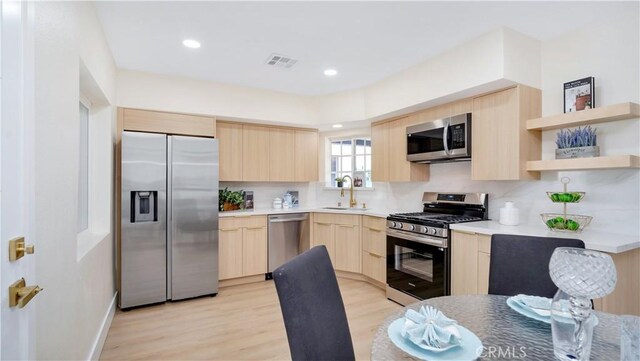 815 N Hagar St, San Fernando, CA 91340 - kitchen with light brown cabinets, stainless steel appliances, light wood finished floors, modern cabinets, and recessed lighting