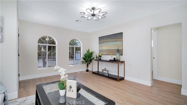 815 N Hagar St, San Fernando, CA 91340 - living room featuring a chandelier and wood finished floors