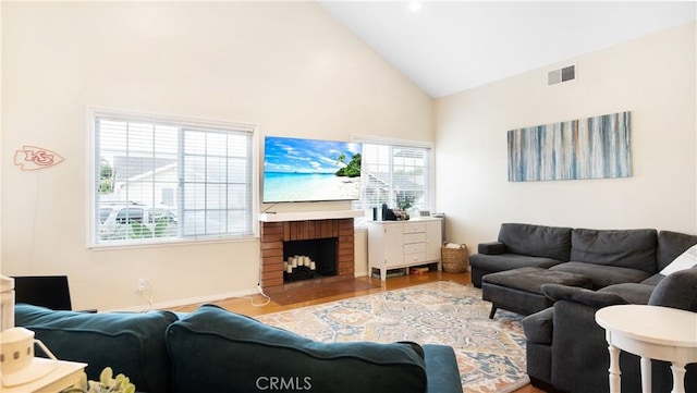 937 Dahlia Ave, Costa Mesa, CA 92626 - living area with high vaulted ceiling, wood finished floors, and a brick fireplace