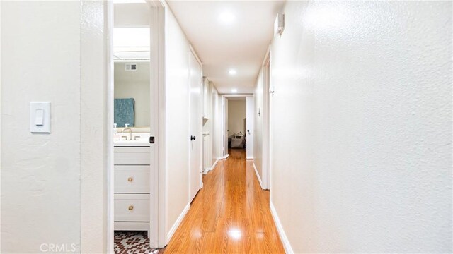 937 Dahlia Ave, Costa Mesa, CA 92626 - hall featuring light wood-type flooring, recessed lighting, and a textured wall
