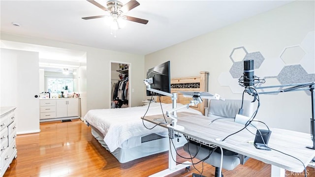 937 Dahlia Ave, Costa Mesa, CA 92626 - bedroom featuring a closet, a spacious closet, light wood-style floors, and a ceiling fan