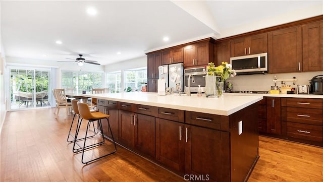 937 Dahlia Ave, Costa Mesa, CA 92626 - kitchen with ceiling fan, recessed lighting, healthy amount of natural light, light countertops, and light wood-style floors
