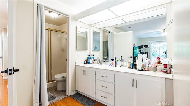937 Dahlia Ave, Costa Mesa, CA 92626 - bathroom featuring vanity, a shower stall, ceiling fan, and wood finished floors