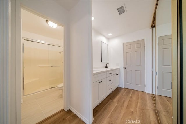 2648 Condor Cir, Corona, CA 92882 - bathroom with vanity, a stall shower, wood finished floors, and recessed lighting