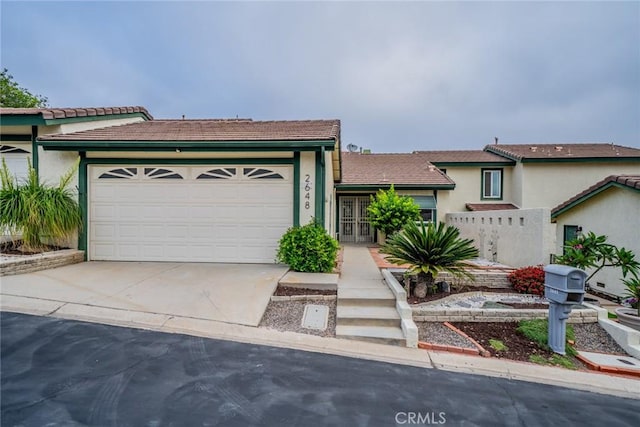 2648 Condor Cir, Corona, CA 92882 - view of front of house featuring driveway, a garage, a tiled roof, and stucco siding
