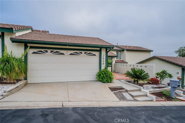 2648 Condor Cir, Corona, CA 92882 - view of front of house with driveway, a tiled roof, an attached garage, and stucco siding