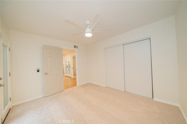 2648 Condor Cir, Corona, CA 92882 - unfurnished bedroom with light colored carpet, a closet, and a ceiling fan